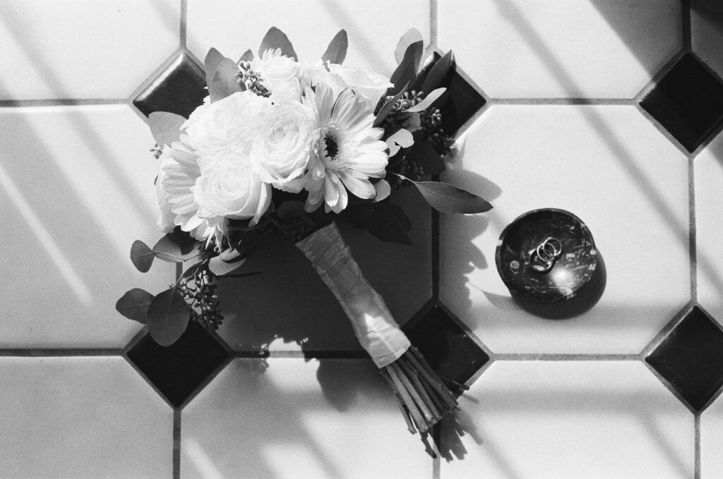 film photo of wedding bouquet and ring details