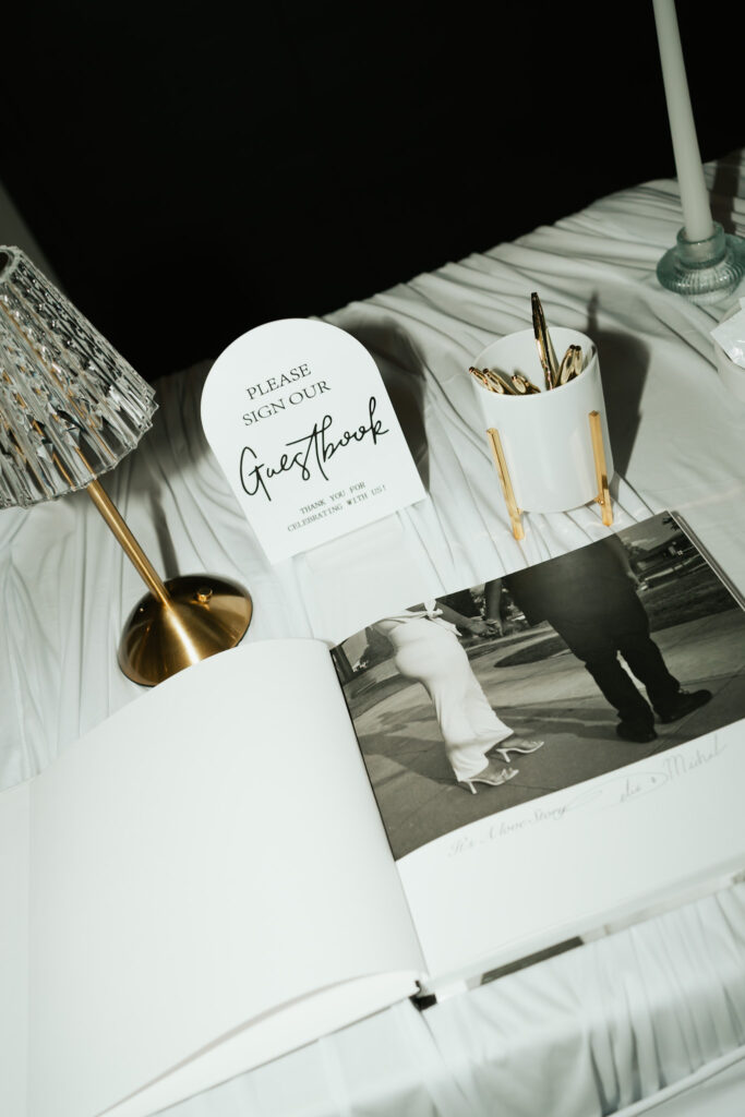 Minimal guest book and layered draped fabric ceremony backdrop at a modern and elegant Arizona wedding.