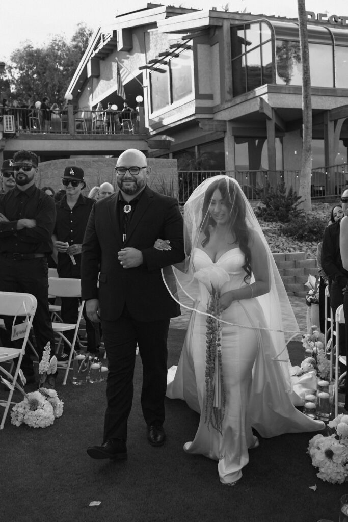 Bride walks down the aisle with her brother for the first time at her modern and minimal wedding in Arizona.