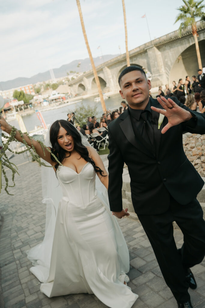 Bride and groom post ceremony in front of the London Bridge during a modern, minimal wedding in Arizona