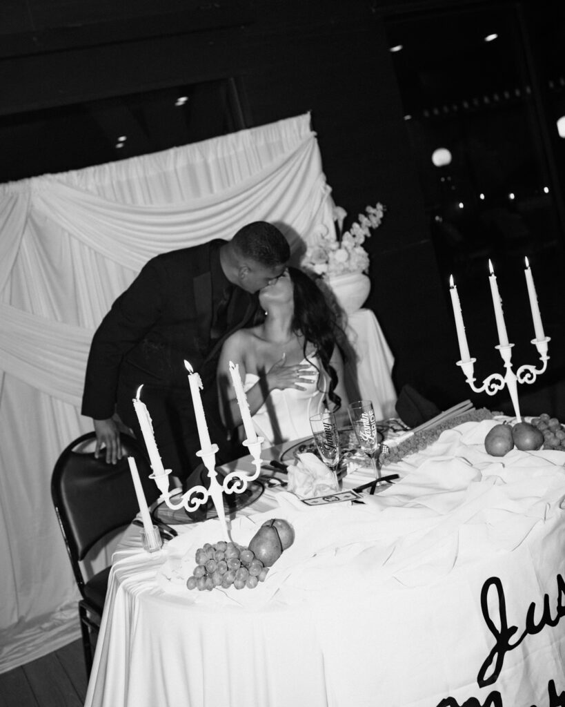 bride and groom kissing during their modern style reception.